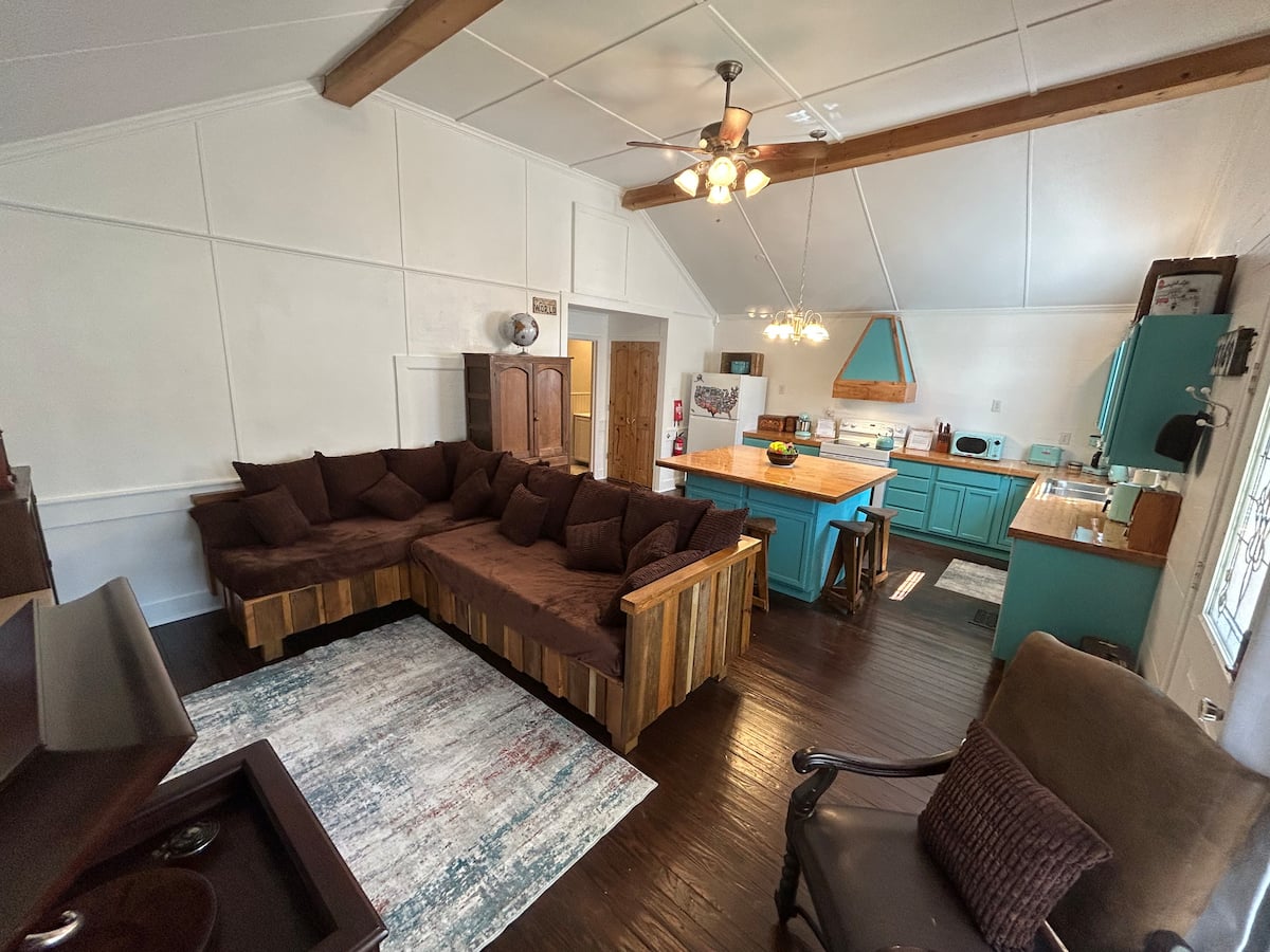 Living room with sectional and kitchen beyond
